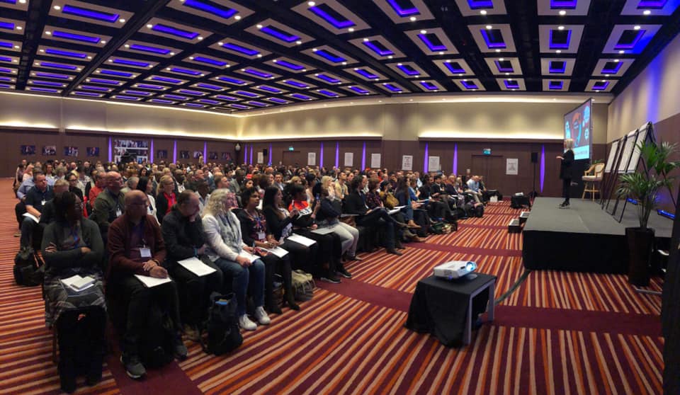Dawn McGruer on the main stage delivering a keynote to hundreds of delegates
