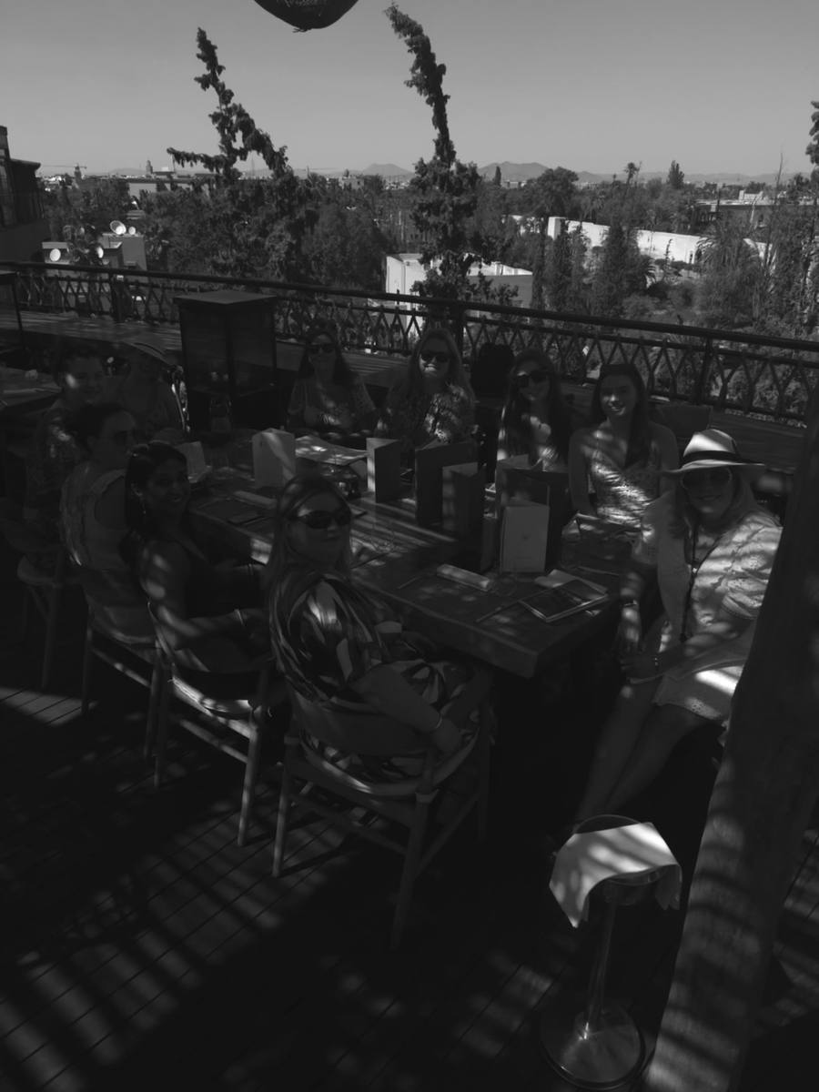 Founders sharing lunch on a sunlit retreat rooftop